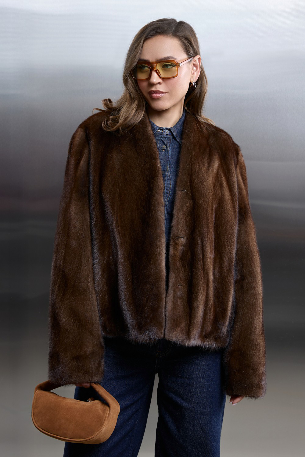 Short brown mink fur coat with satin lining, styled elegantly for a sophisticated look.